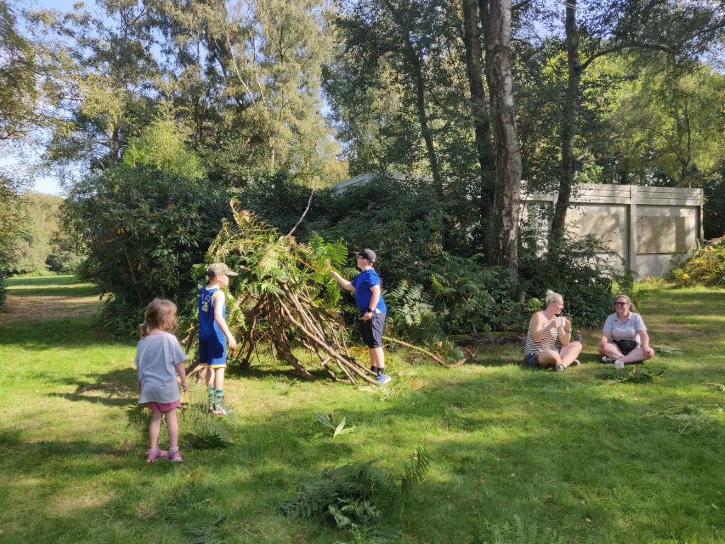 Children building a den from natural materials