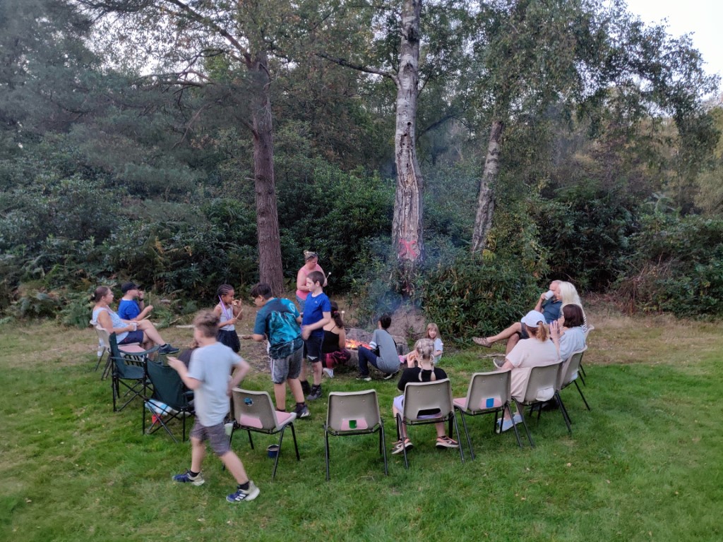 Toasting marshmallows to make 'smores' around a camp fire